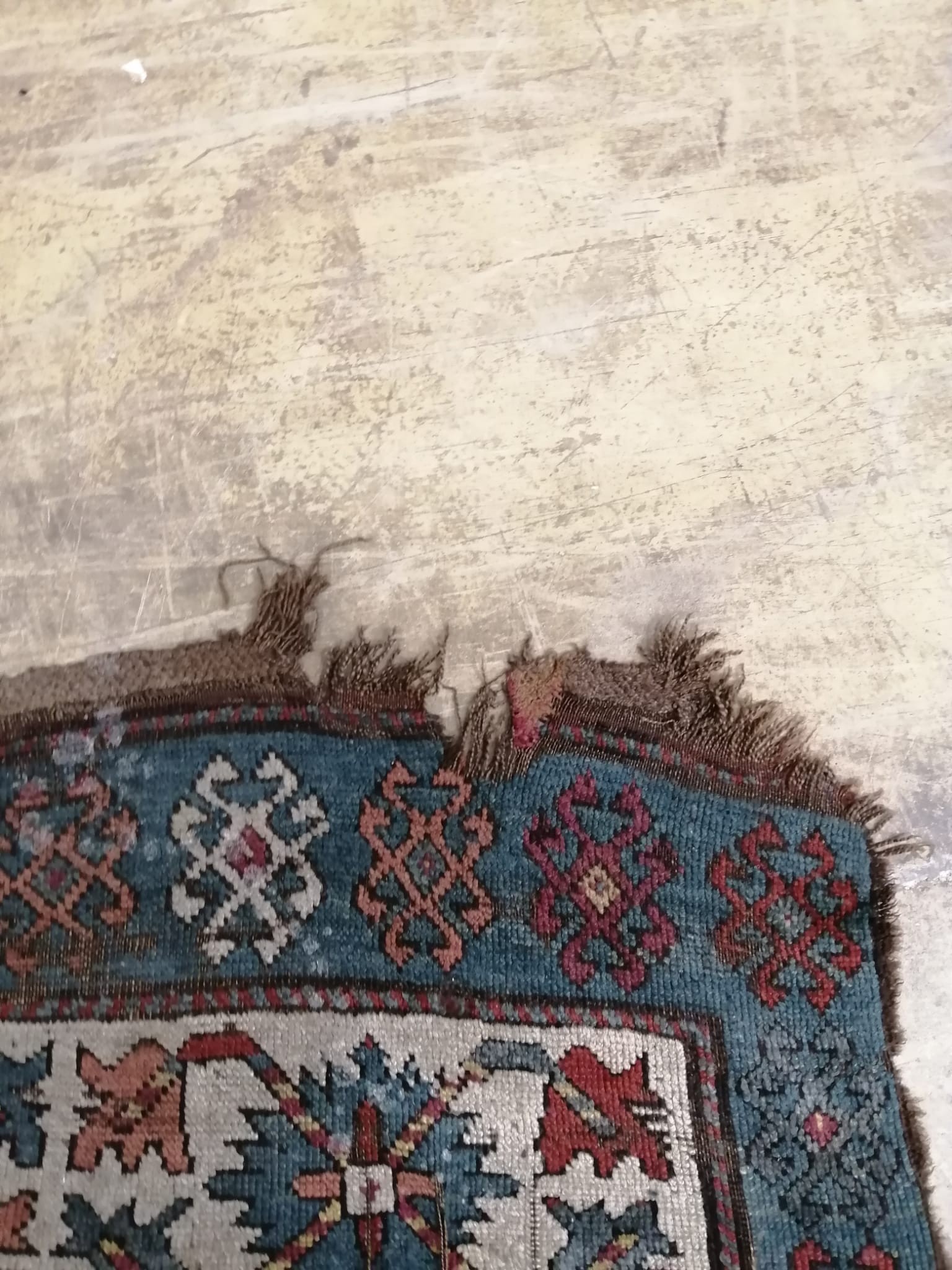 An antique Kazak rug, 310 x 150cm